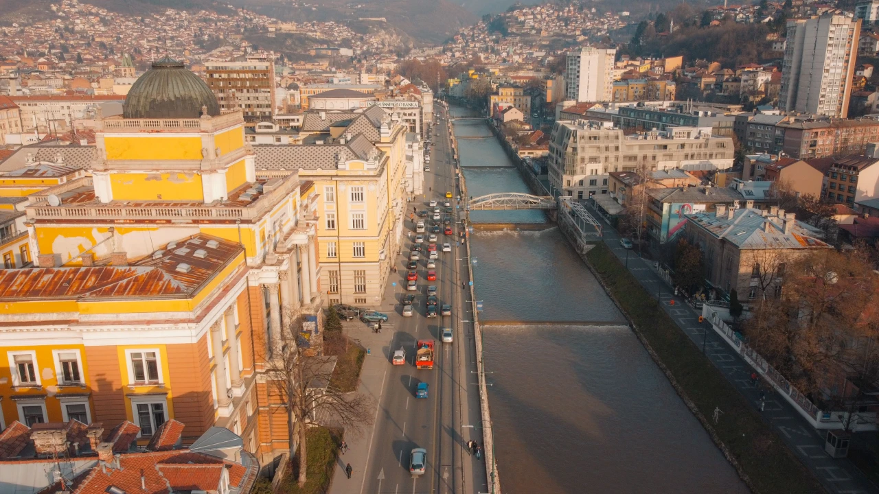 Aerial view of Sarajevo's Old Town and the Miljacka River, showing the mix of Ottoman and Austro-Hungarian architecture